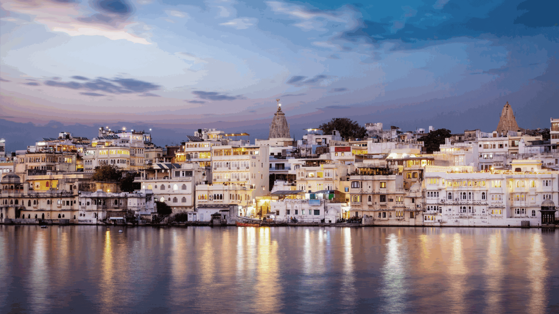 Evening view of Udaipur’s illuminated lakeside architecture, representing India’s evolving family office landscape and growing influence in wealth management