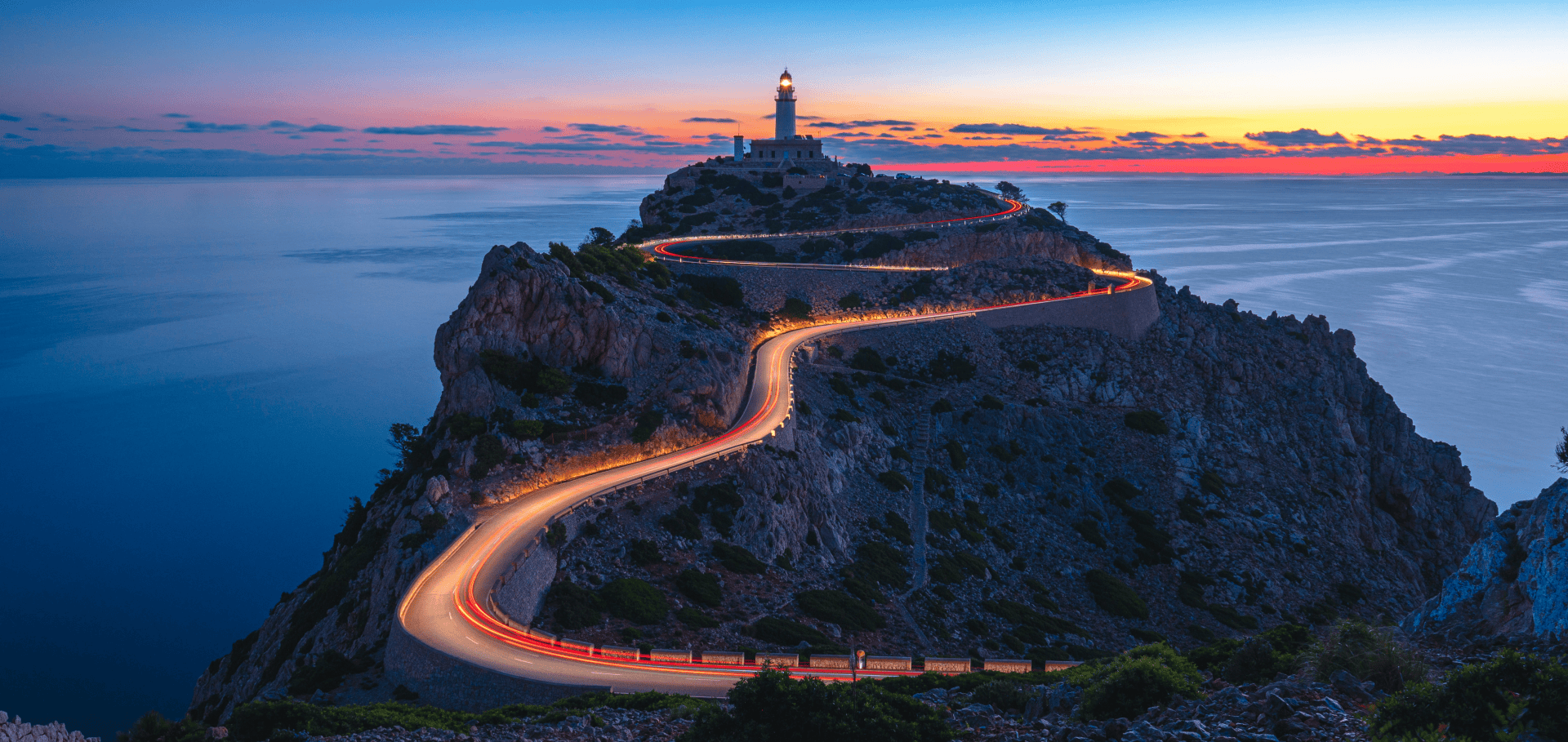 Winding coastal road leading to a lighthouse at sunset, symbolising direction and guidance for family offices Winding coastal road leading to a lighthouse at sunset, symbolising direction and guidance for family offices
