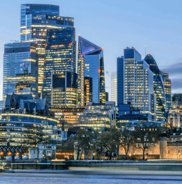London financial district skyline at dusk with illuminated skyscrapers and River Thames in the foreground London financial district skyline at dusk with illuminated skyscrapers and River Thames in the foreground