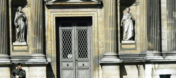 Classical building façade with guard symbolising protection, discipline, and strategy in family office security