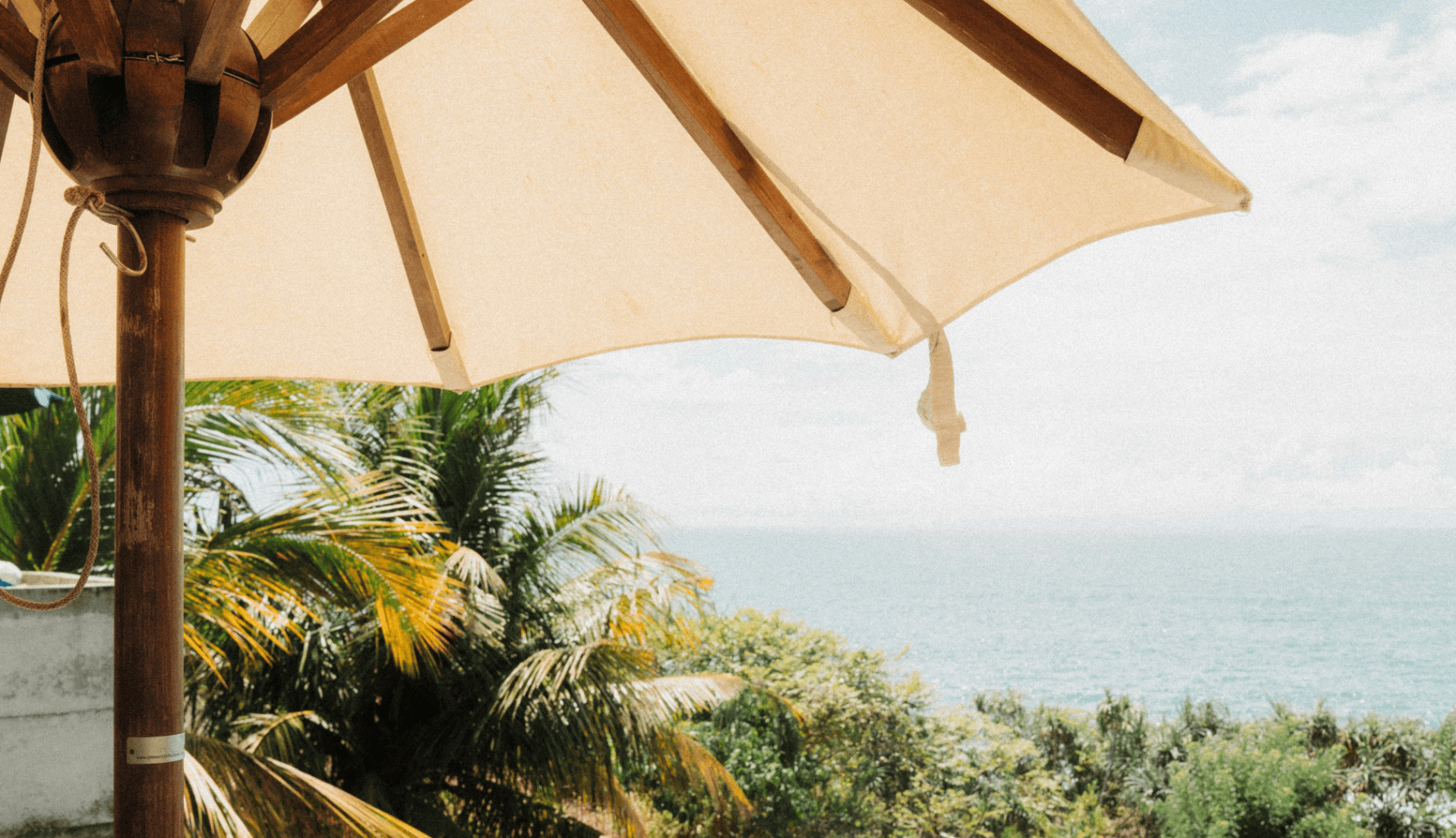 A luxury outdoor setting overlooking the ocean, representing discreet lifestyle support and digital concierge services for family offices.