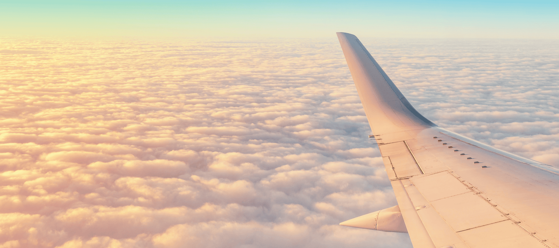 Private jet wing above clouds at sunset illustrating Maison Benjamin’s high-level family office concierge and crisis management services