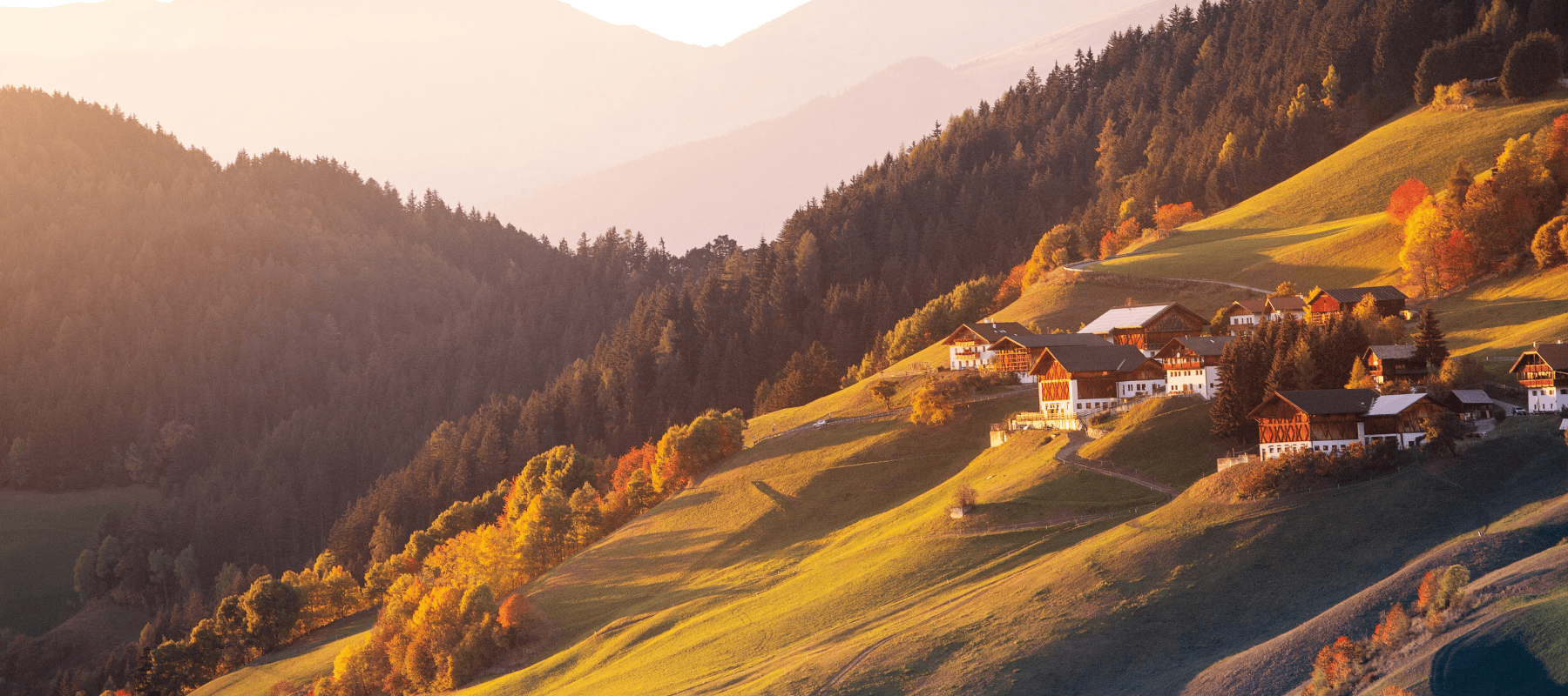 Swiss alpine valley with hillside village and autumn landscape, representing Switzerland as a global hub for family offices
