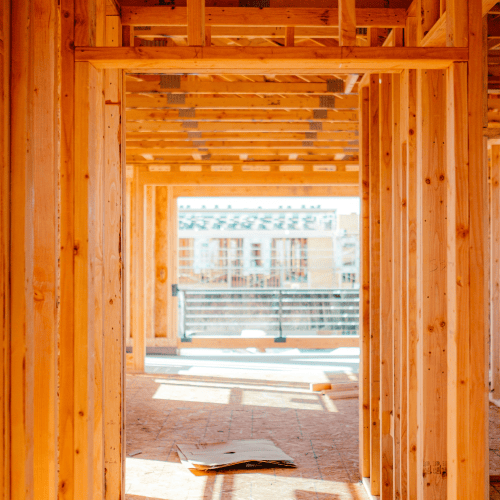 Interior view of a wooden building frame under construction, symbolizing the structural evolution of a family office in 2026.